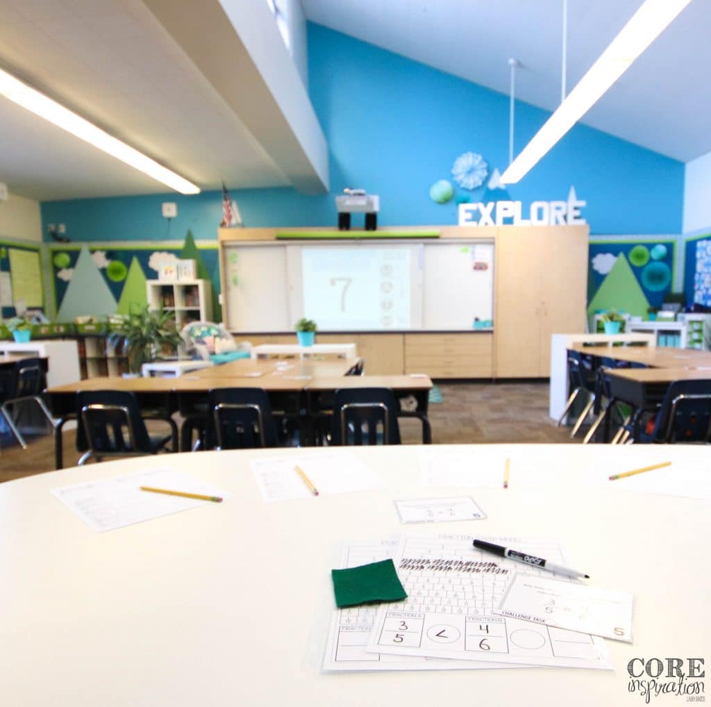 Small group arrangement at back table with digital transition deck displayed on whiteboard. 