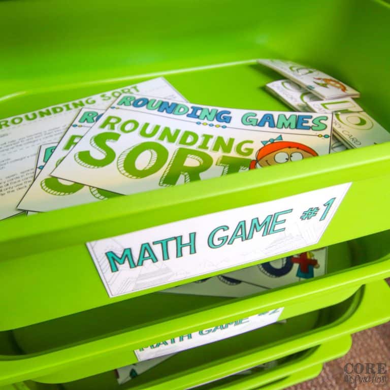 Math game instruction cards arranged in green storage drawers