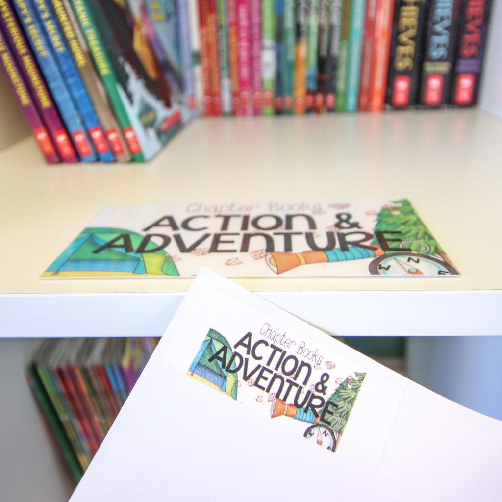 Core Inspiration's classroom library labeling kit showing the action/adventure shelf in her classroom library along with a book labeled with a matching sticker. 