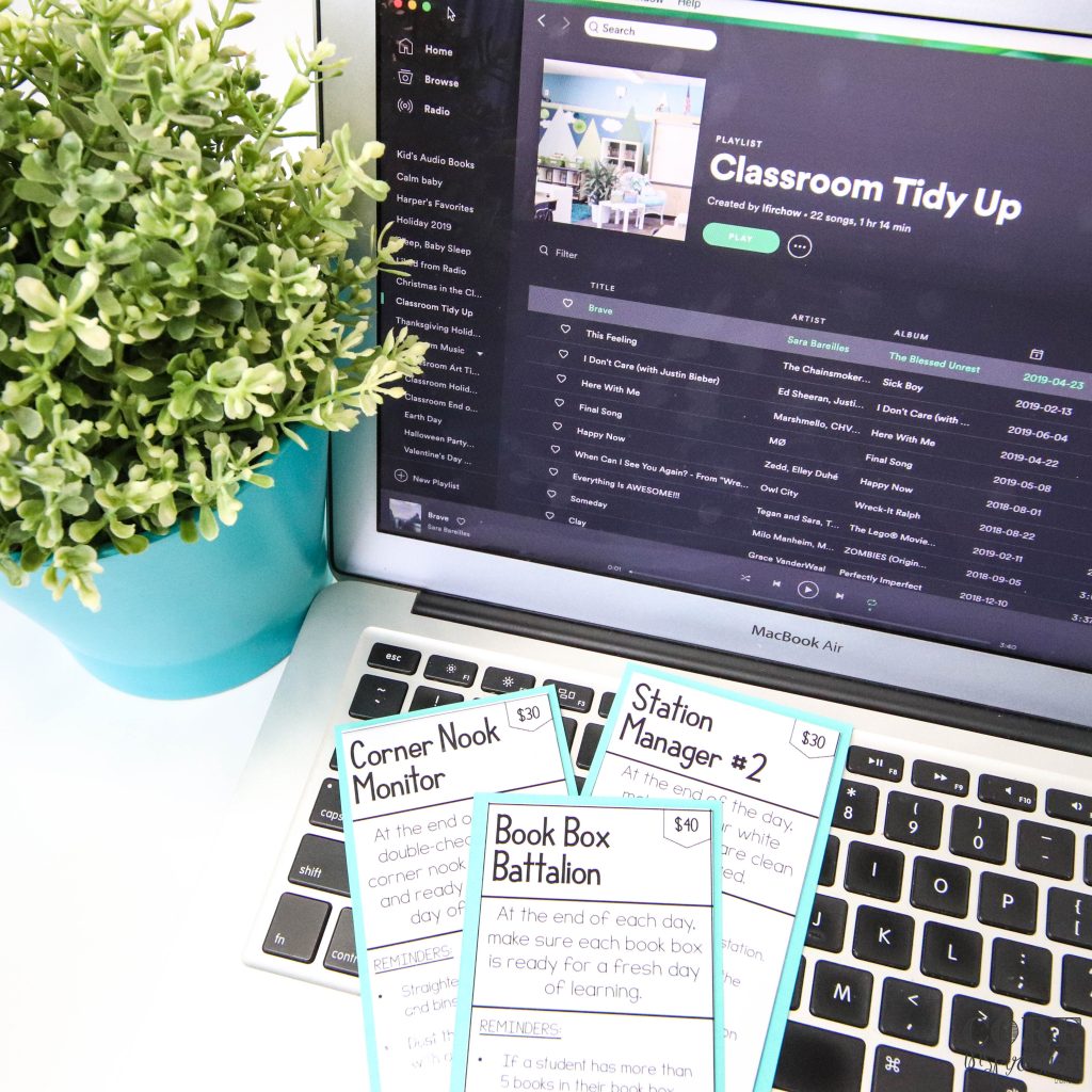 Core Inspiration Classroom Job cards laying on top of laptop keyboard with tidy up time Spotify playlist in background