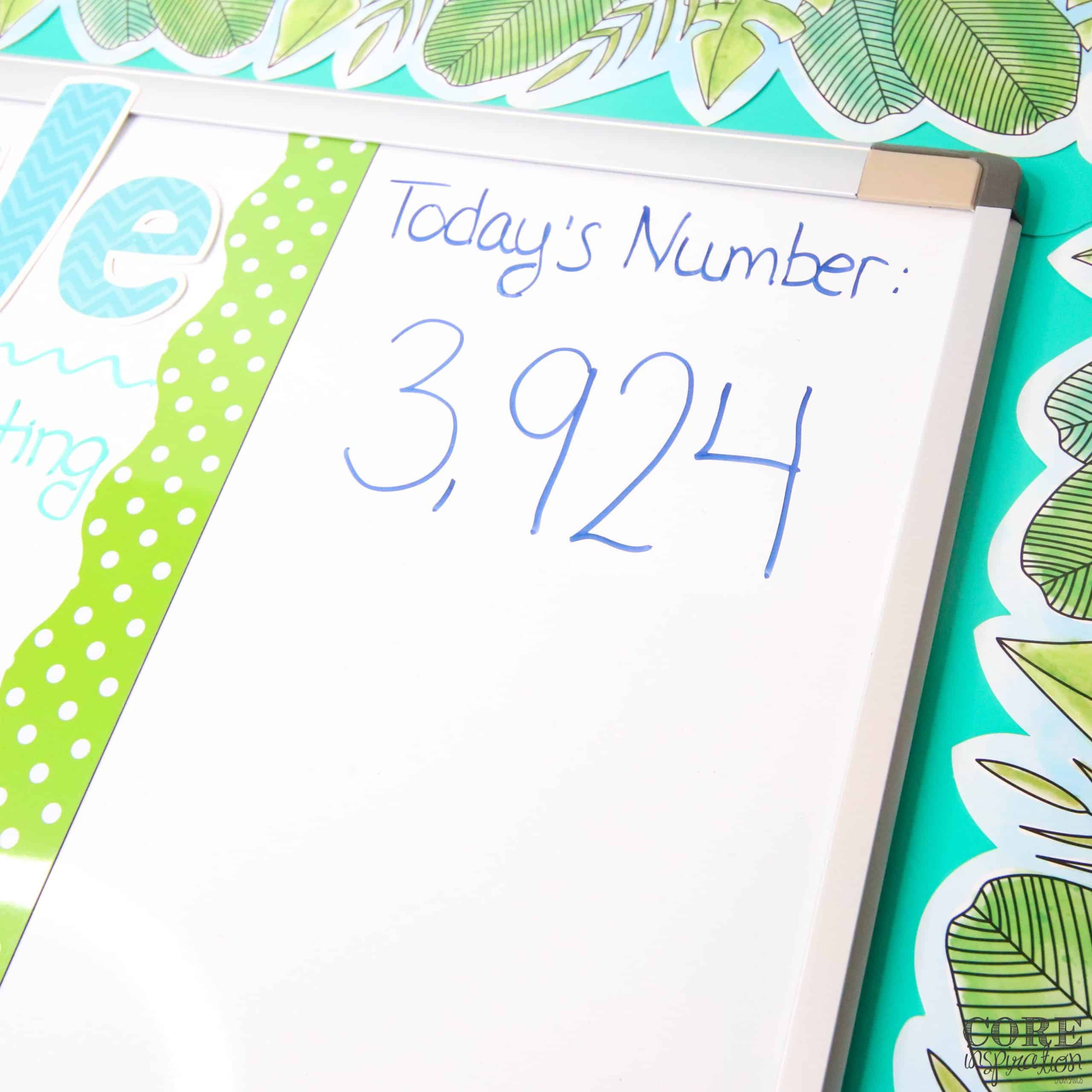 Today's number (3,924) written on classroom whiteboard next to the daily schedule.