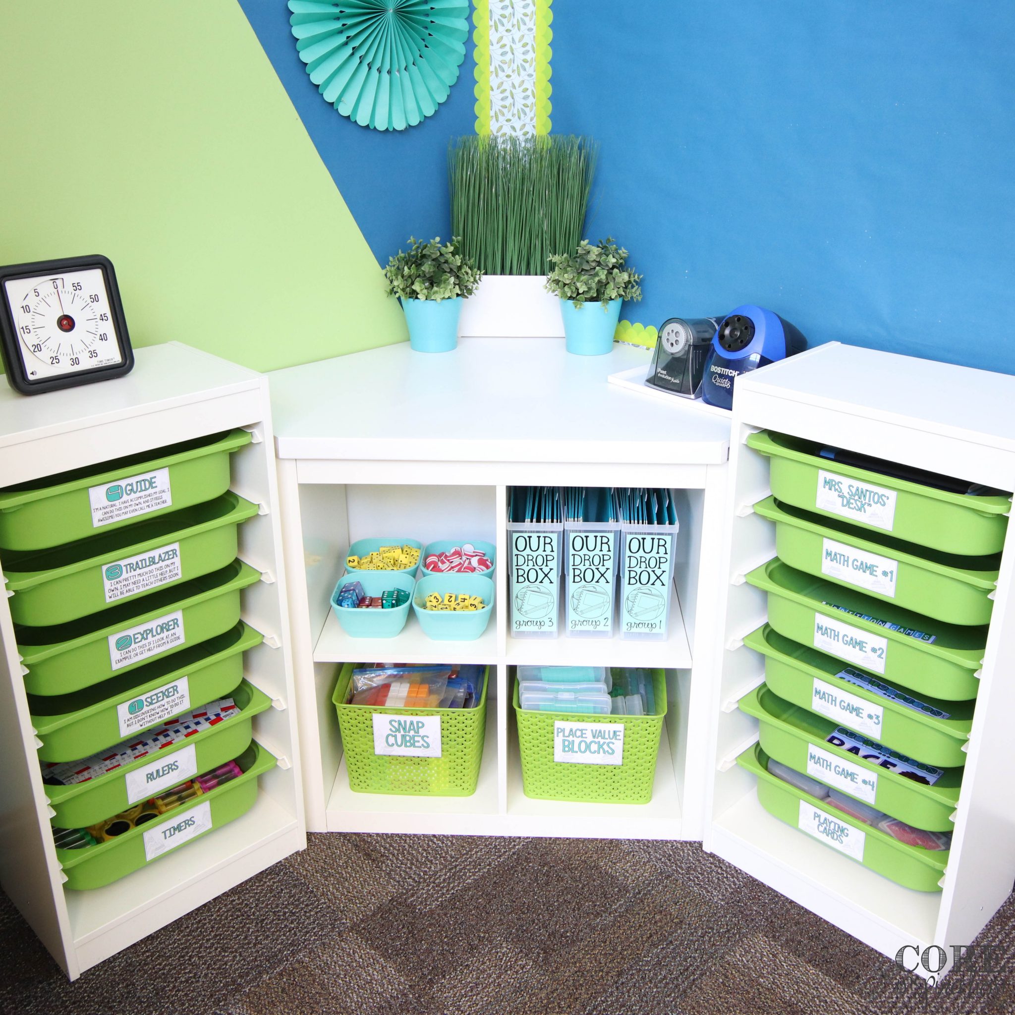 Shelf in the corner of the classroom where all the math workshop manipulatives and supplies are organized and easily accessible to students so they can work more independently during math rotations.