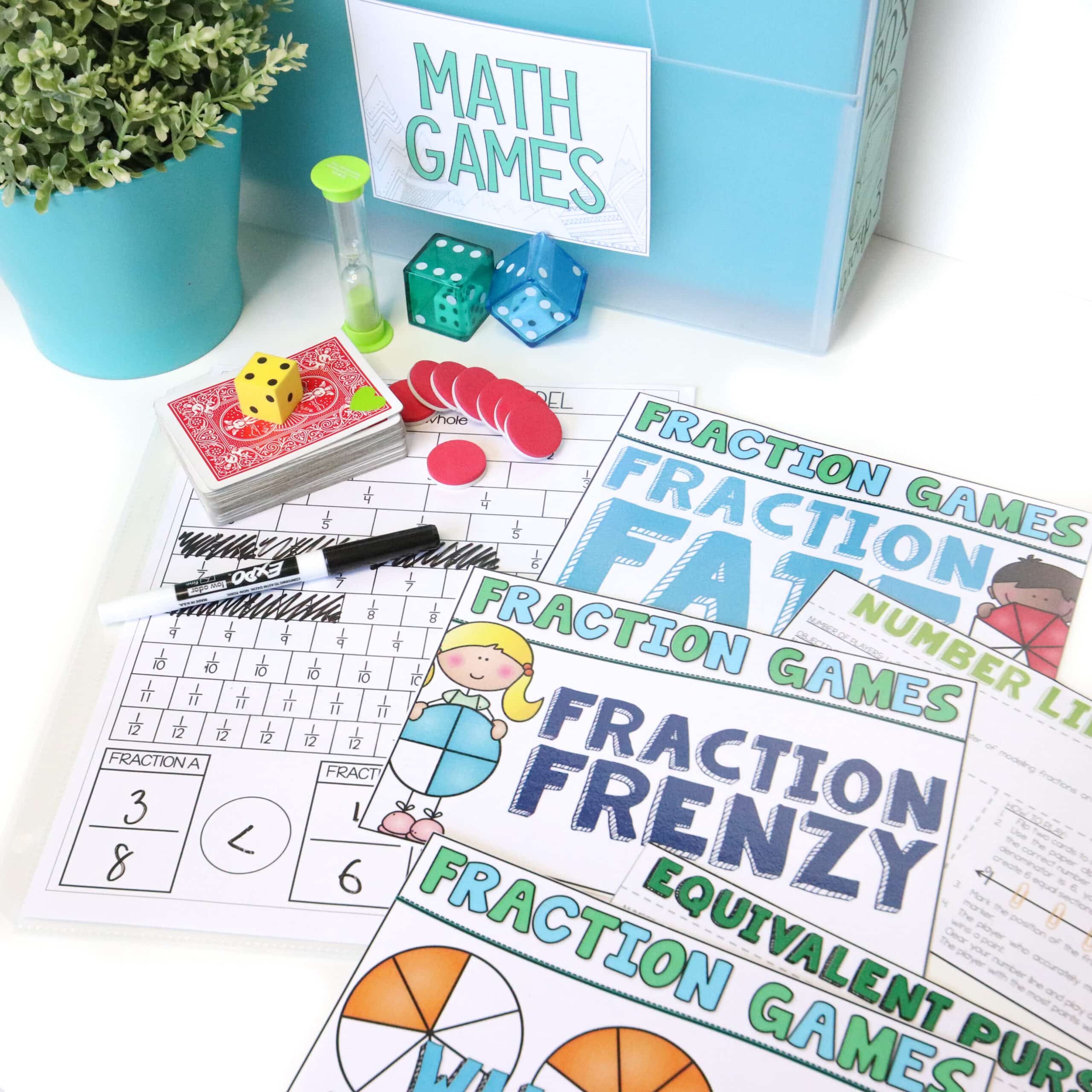 Core Inspiration's collection of hands-on fraction math games for third grade laying on the desk next to math manipulatives like counters, dice, and timers. 